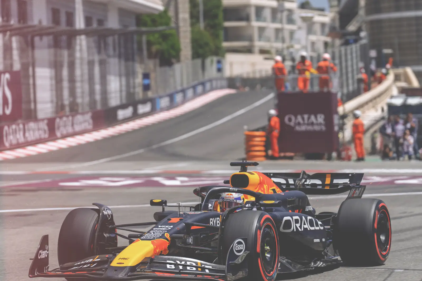 Formula 1 cars racing on track at a major motorsport event.
