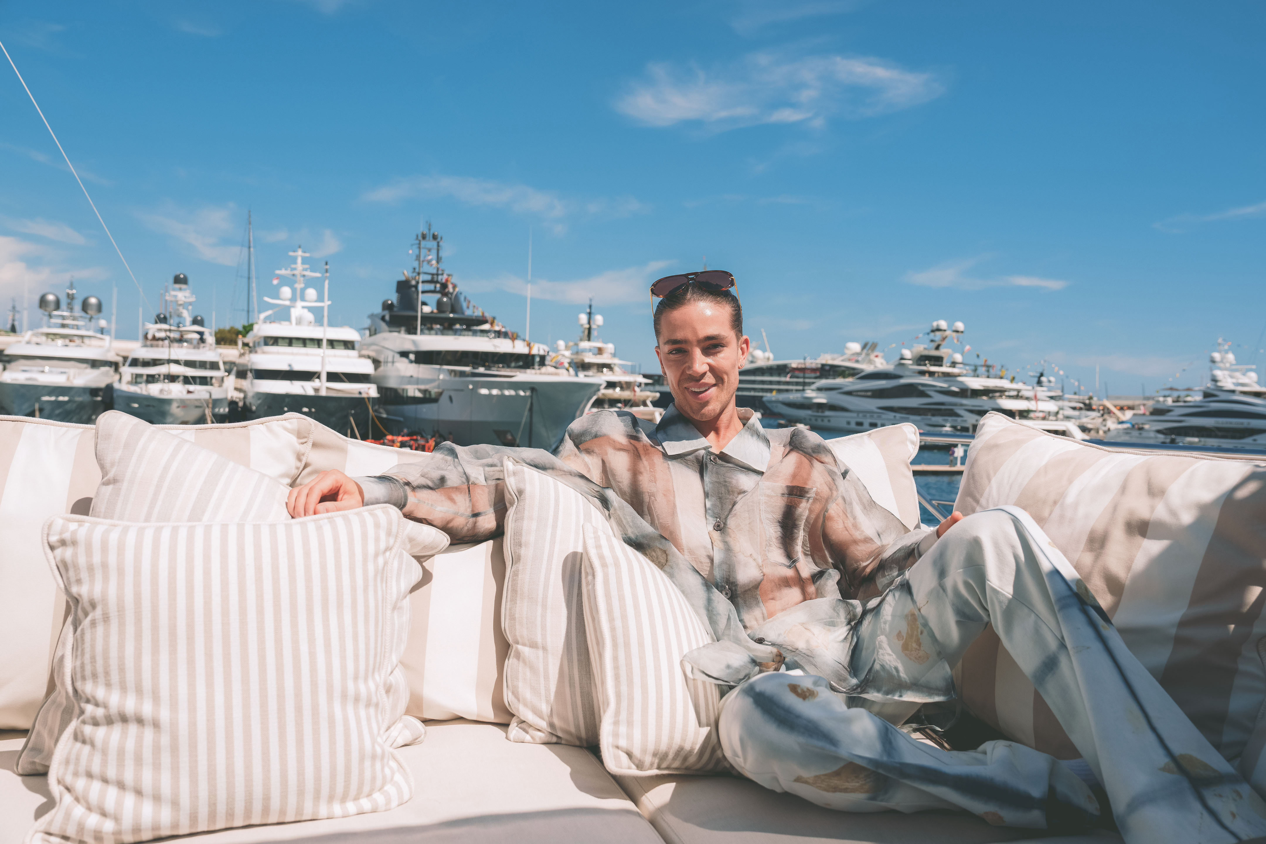 Hospitality host on a yacht deck with guests.