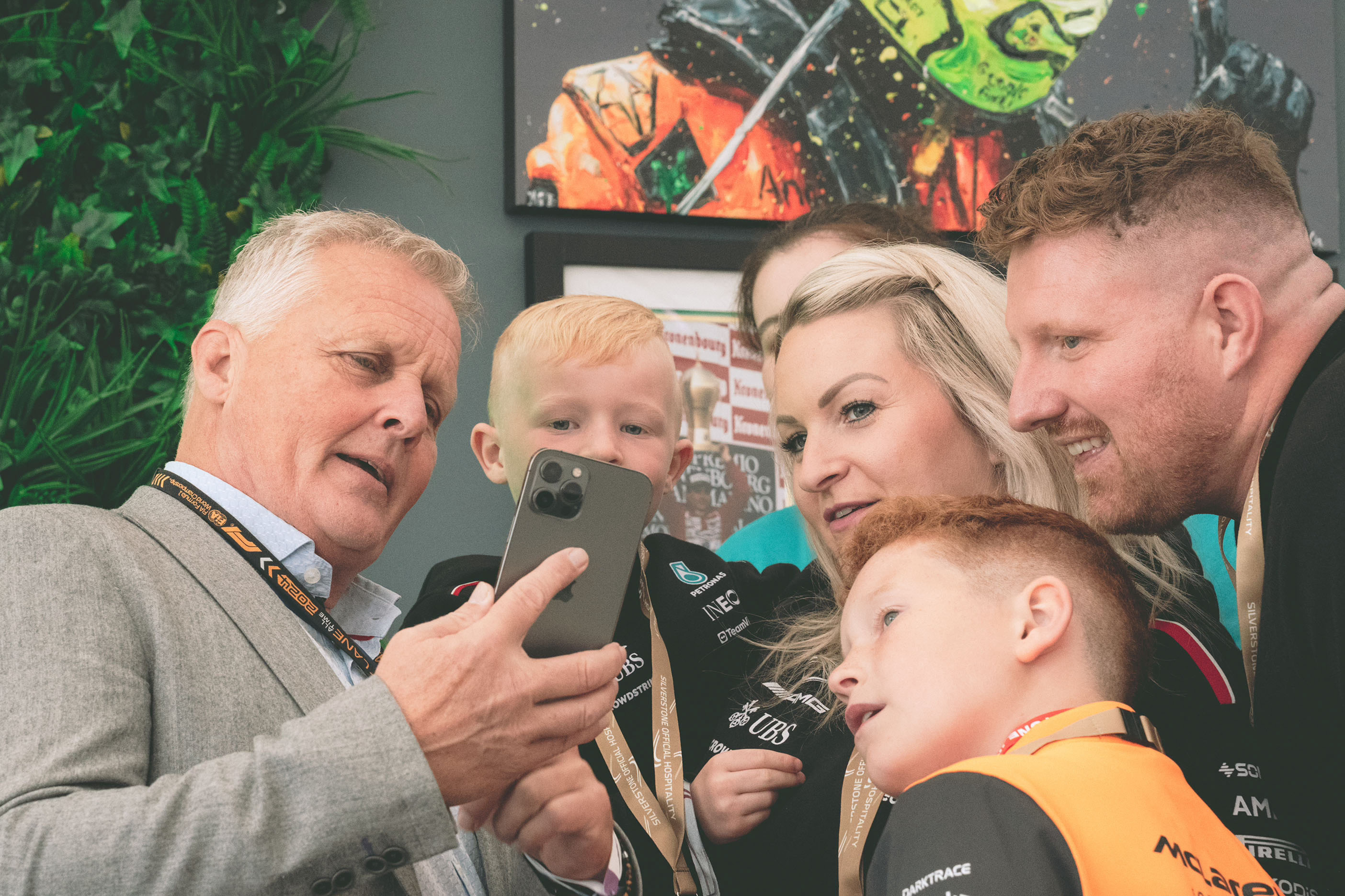 Sporting host taking a selfie with guests.