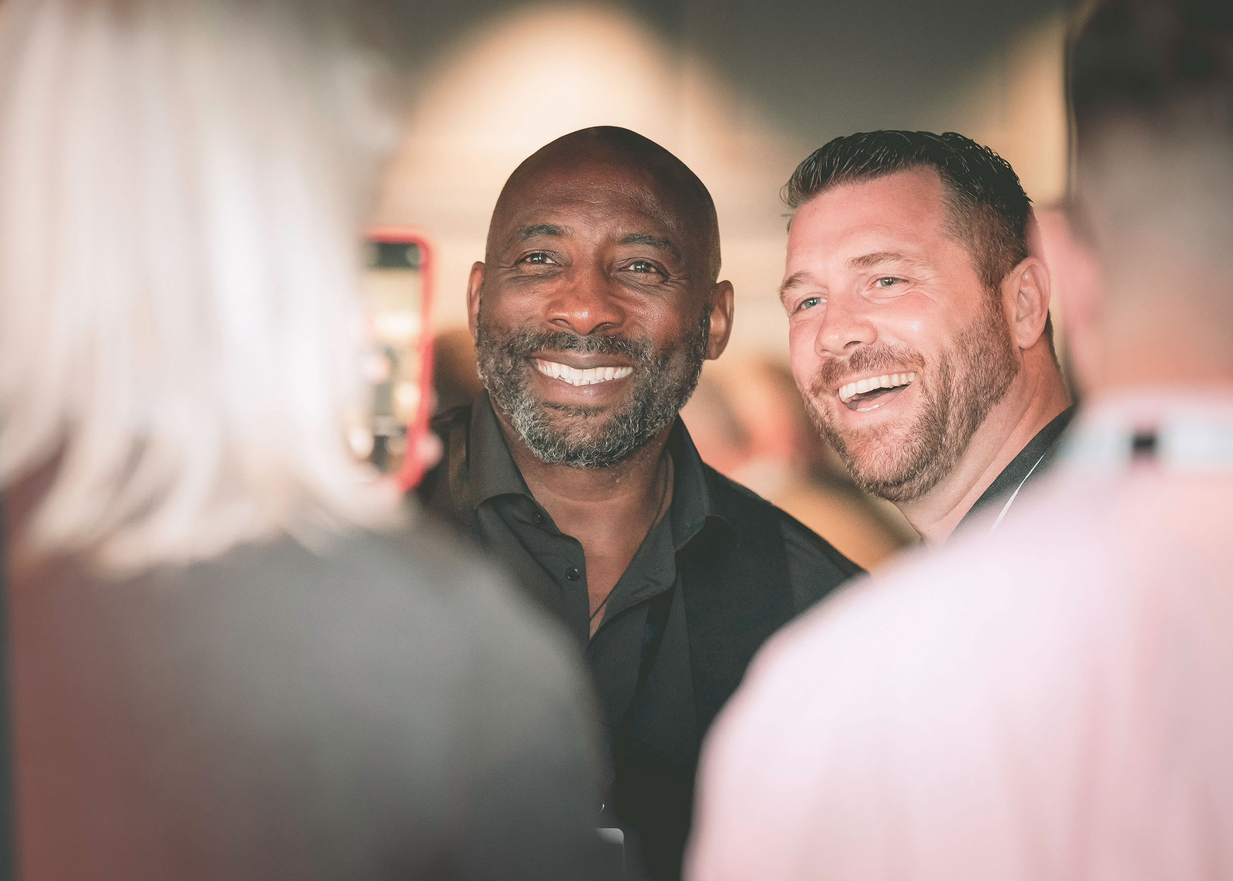 Sporting legend smiling with Green Room guests.